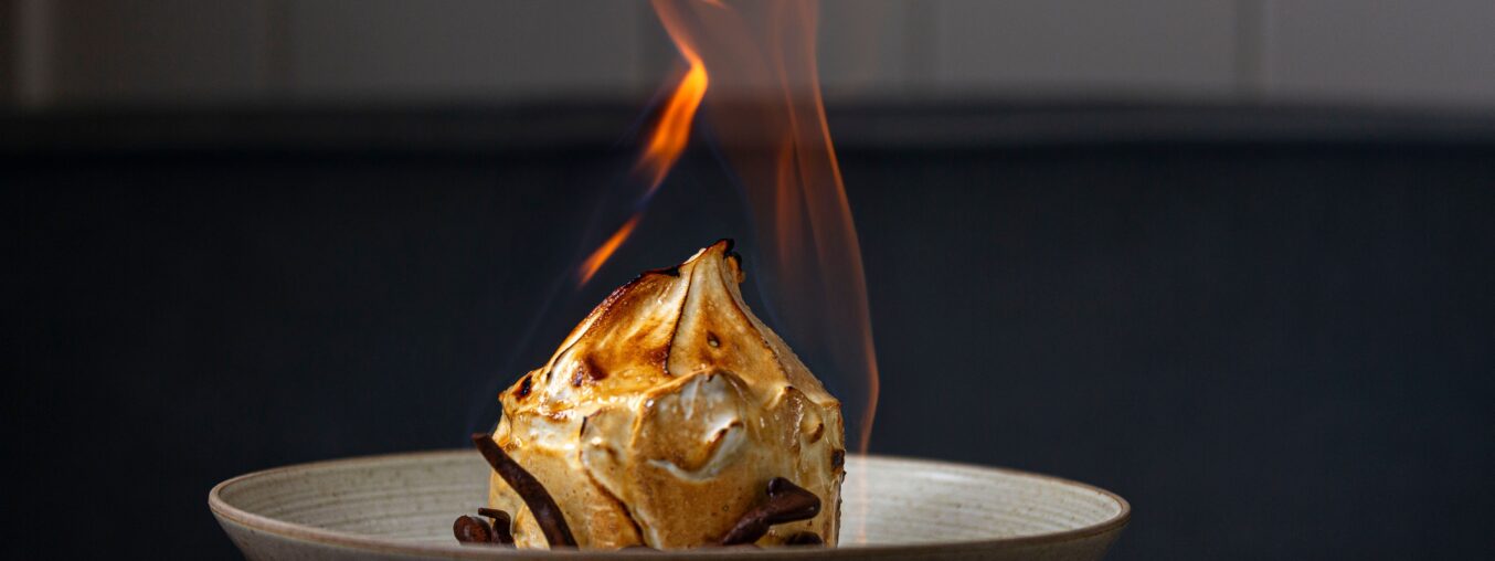 The Baked Alaska is making headlines once more.  

(Note: The original phrase "on fire" is often used metaphorically to mean gaining attention or popularity, similar to "trending."
