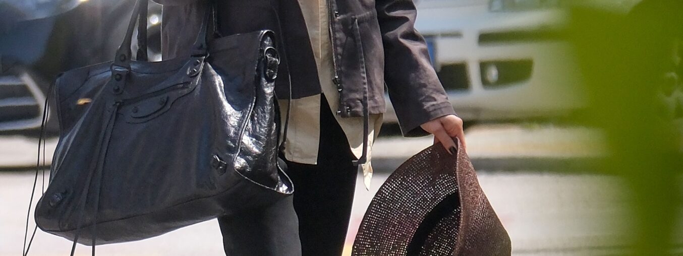 Lily Collins swaps her suitcase for a massive Balenciaga City Bag