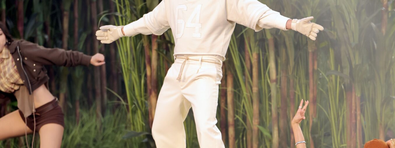 The story behind Bad Bunny's 2026 Super Bowl outfit for Zara, including his "64" jersey.